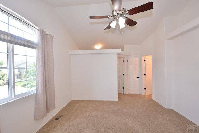 1135 Mount Estes Dr, Colorado Springs, CO 80921 - empty room with a ceiling fan, healthy amount of natural light, light colored carpet, and vaulted ceiling