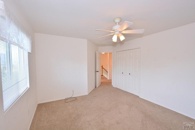 1135 Mount Estes Dr, Colorado Springs, CO 80921 - unfurnished bedroom with light colored carpet, a closet, and ceiling fan