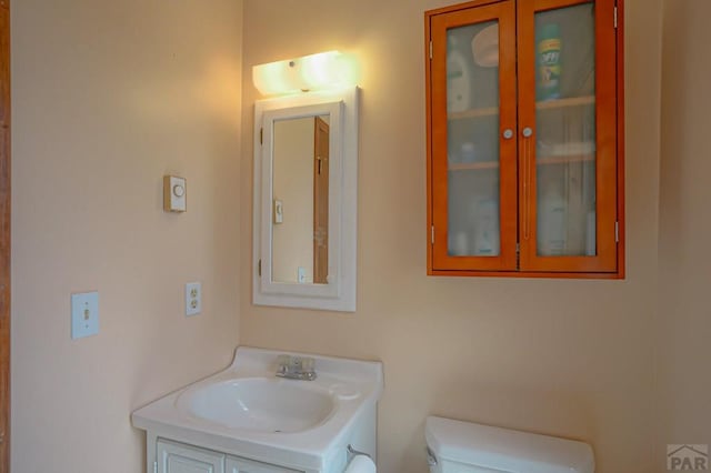 half bathroom featuring toilet and vanity