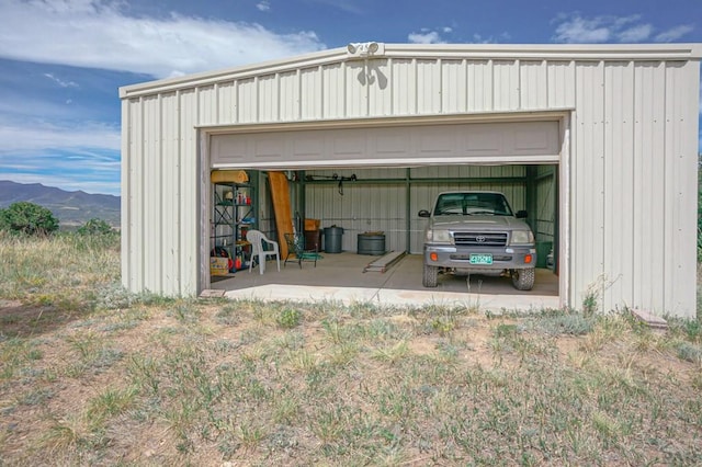 detached garage featuring a mountain view