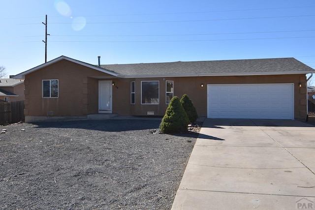 ranch-style house featuring stucco siding, an attached garage, driveway, and roof with shingles