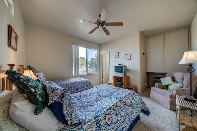 bedroom with a ceiling fan and light colored carpet