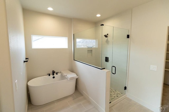 full bathroom with a soaking tub, a shower stall, a wealth of natural light, and recessed lighting