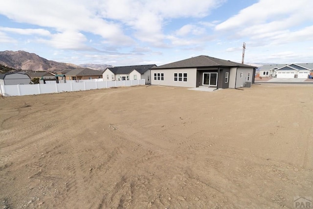 rear view of house with fence