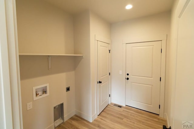 clothes washing area featuring laundry area, light wood-style flooring, hookup for a washing machine, hookup for an electric dryer, and recessed lighting