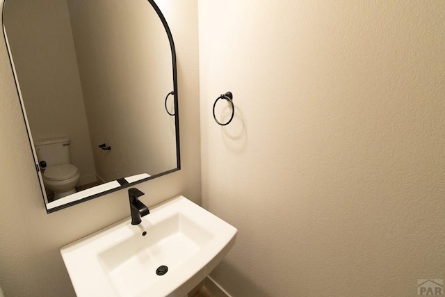 bathroom with a sink and toilet