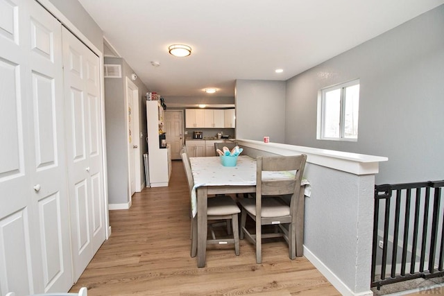 1710 E 3rd St, Pueblo, CO 81001 - dining space featuring light wood-style floors, baseboards, and visible vents