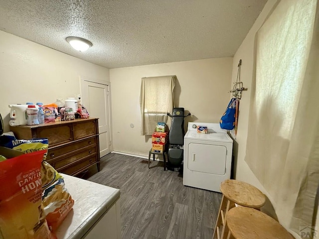washroom featuring laundry area, a textured ceiling, dark wood-style flooring, and washer / dryer