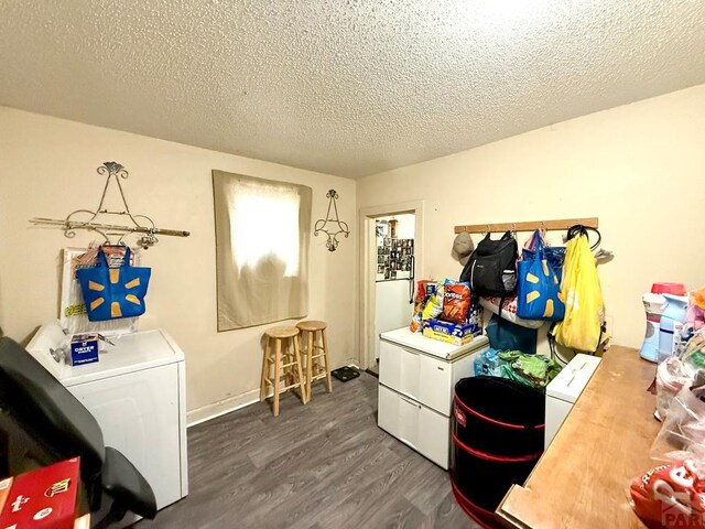 clothes washing area featuring laundry area, a textured ceiling, dark wood-style flooring, and washer / clothes dryer