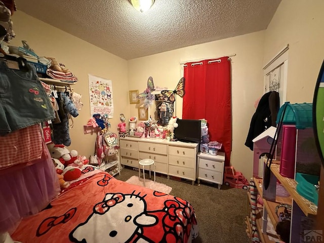 bedroom with a textured ceiling and carpet floors