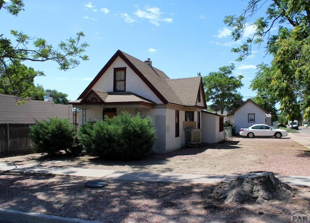view of front of home with stucco siding and fence