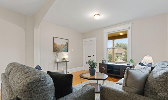 329 Washington St, Pueblo, CO 81004 - living room featuring wood finished floors and arched walkways