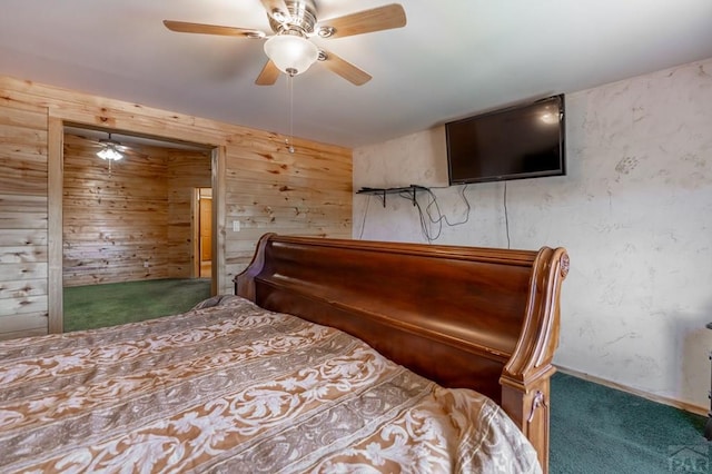 bedroom with carpet flooring, ceiling fan, and wooden walls