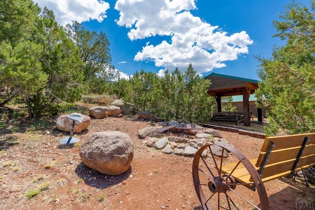 view of yard with an outdoor fire pit and a gazebo