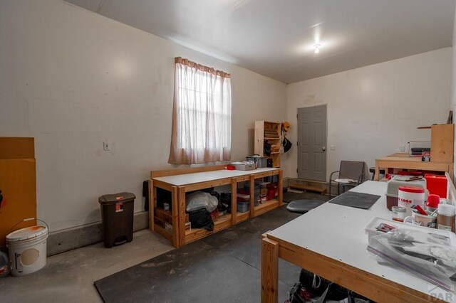 interior space featuring concrete floors and a workshop area