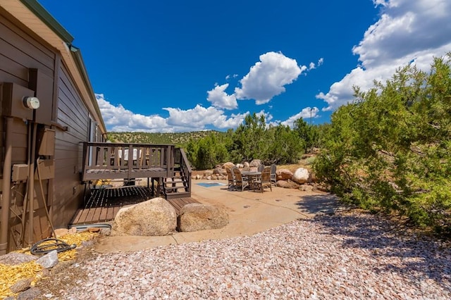 view of yard with a patio area, an outdoor pool, and a wooden deck