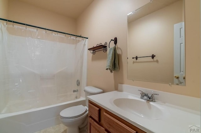 full bathroom with vanity, shower / bath combo with shower curtain, and toilet