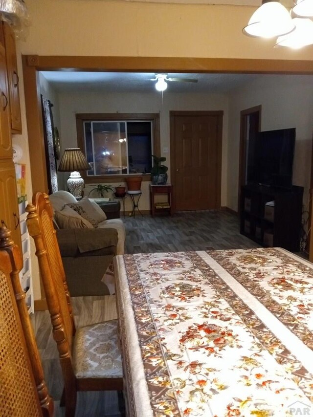 living room featuring dark wood-style flooring and ceiling fan