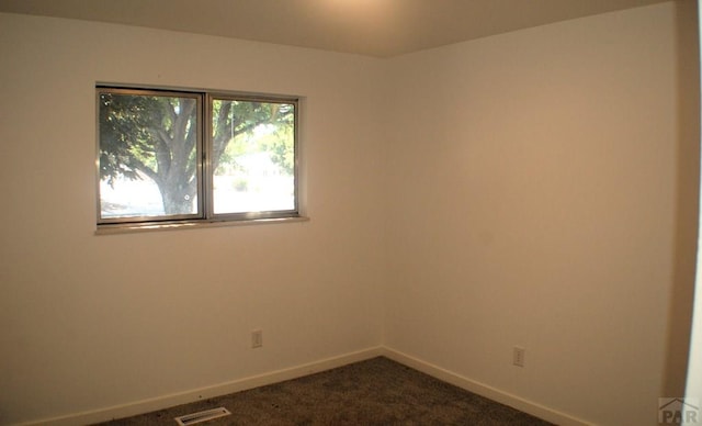 33 Regency Blvd, Pueblo, CO 81005 - unfurnished room with baseboards and dark carpet