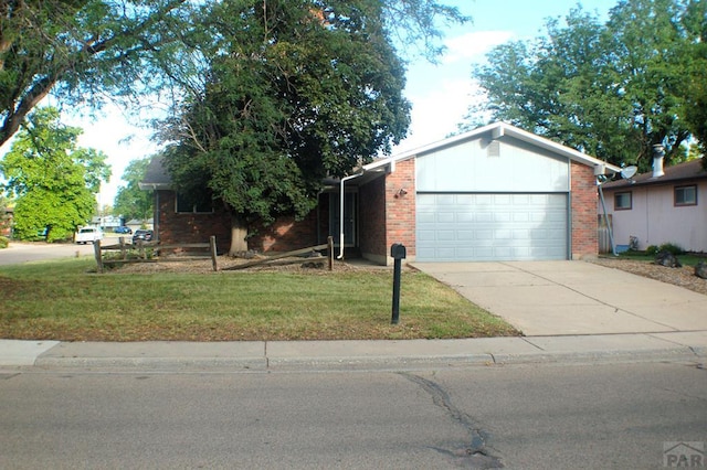 33 Regency Blvd, Pueblo, CO 81005 - ranch-style house with brick siding, a garage, and driveway