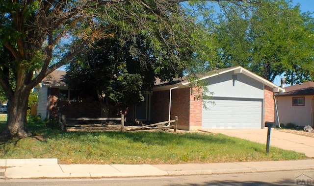 33 Regency Blvd, Pueblo, CO 81005 - view of front of home with brick siding, an attached garage, and concrete driveway