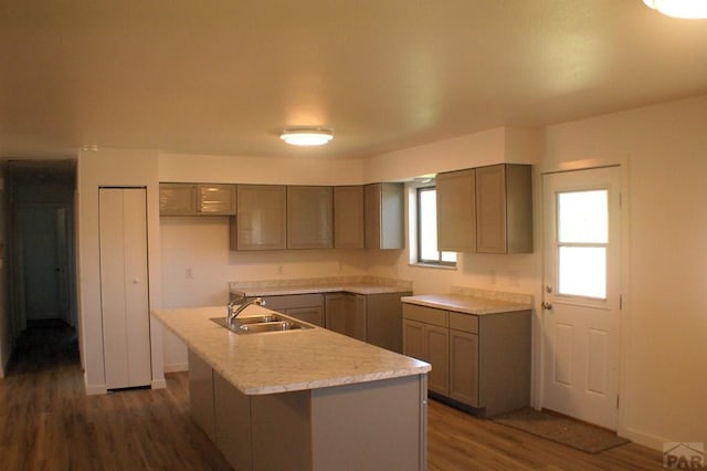33 Regency Blvd, Pueblo, CO 81005 - kitchen with gray cabinetry, dark wood finished floors, an island with sink, and light countertops