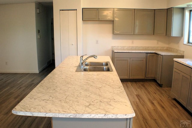 33 Regency Blvd, Pueblo, CO 81005 - kitchen featuring dark wood-style floors, light countertops, and an island with sink