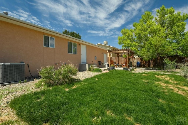 228 S Caddoa Dr, Pueblo West, CO 81007 - back of house featuring central AC, a pergola, stucco siding, and a patio area