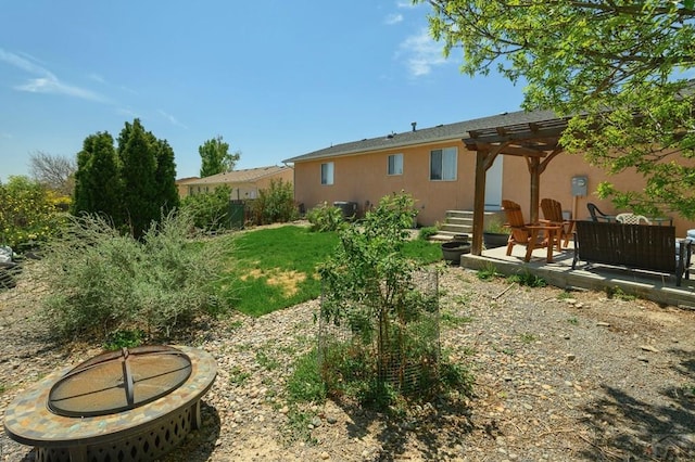 228 S Caddoa Dr, Pueblo West, CO 81007 - view of yard featuring an outdoor fire pit, a pergola, and a patio