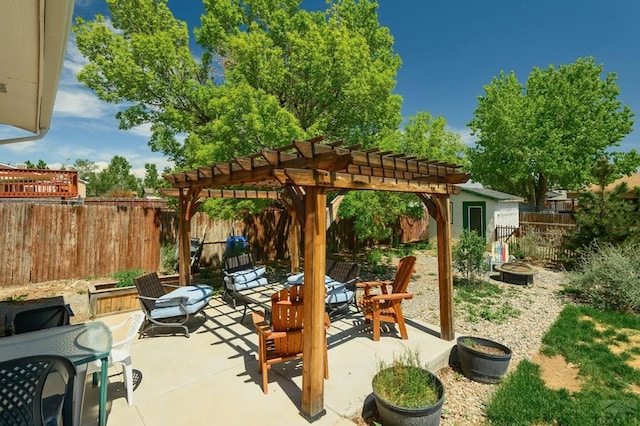 228 S Caddoa Dr, Pueblo West, CO 81007 - view of patio featuring a fire pit, a pergola, and a fenced backyard