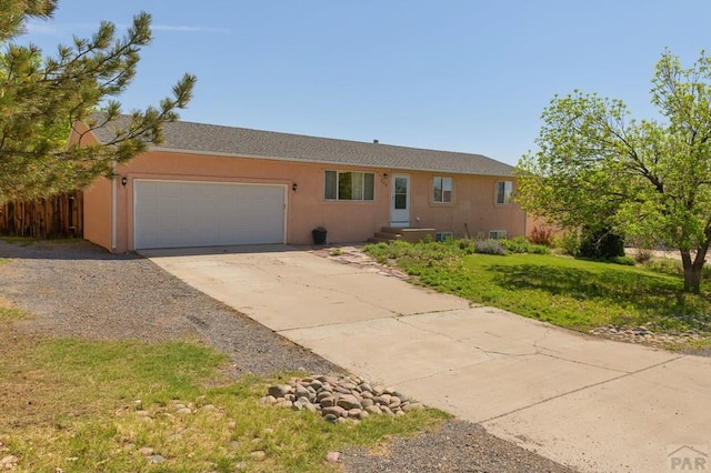 228 S Caddoa Dr, Pueblo West, CO 81007 - single story home featuring an attached garage, driveway, and stucco siding