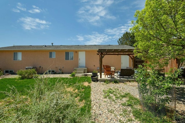 228 S Caddoa Dr, Pueblo West, CO 81007 - rear view of property featuring a pergola, entry steps, stucco siding, and a patio area