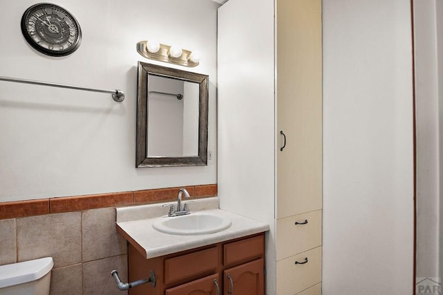228 S Caddoa Dr, Pueblo West, CO 81007 - half bath with toilet, vanity, and tile walls
