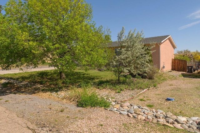 228 S Caddoa Dr, Pueblo West, CO 81007 - view of side of home with fence and stucco siding