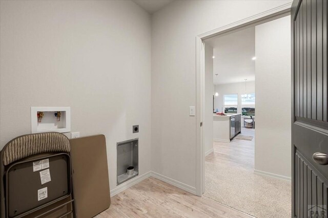 laundry area with hookup for an electric dryer, laundry area, washer hookup, baseboards, and light wood-style floors