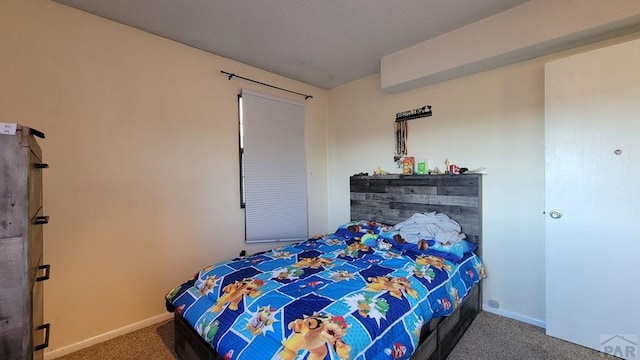 carpeted bedroom featuring baseboards