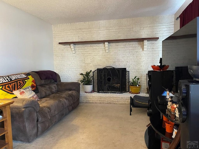 living area with brick wall, a fireplace, a textured ceiling, and light colored carpet