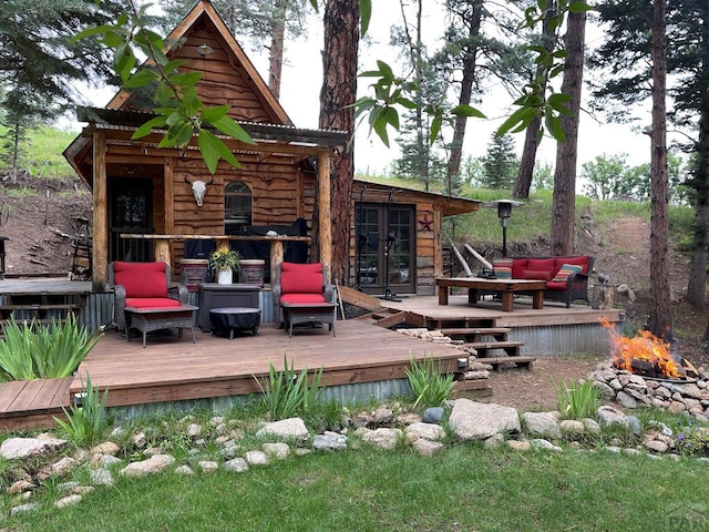 10421 Linger Longer Ln, Rye, CO 81069 - wooden deck with french doors and an outdoor living space with a fire pit