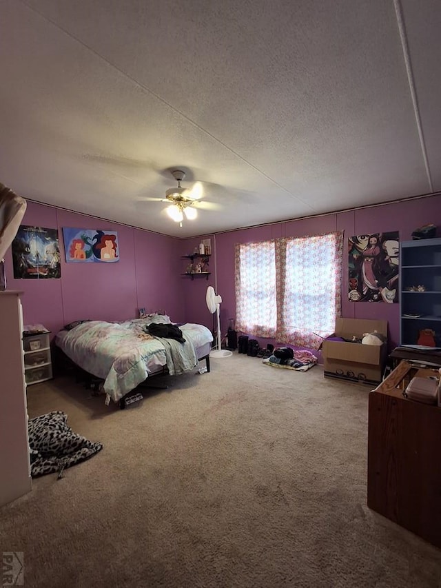 bedroom with carpet floors, ceiling fan, and a textured ceiling