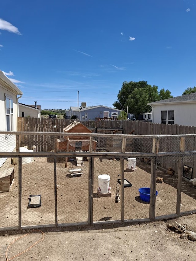 view of yard featuring a fenced backyard and an outdoor structure