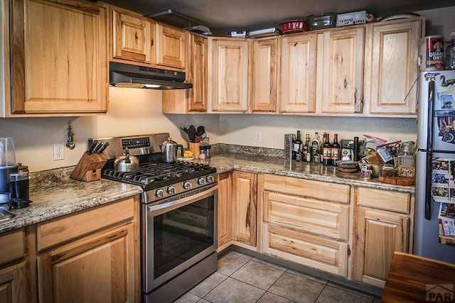 8946 Central Ave, Beulah, CO 81023 - kitchen featuring appliances with stainless steel finishes, under cabinet range hood, tile patterned floors, and stone countertops