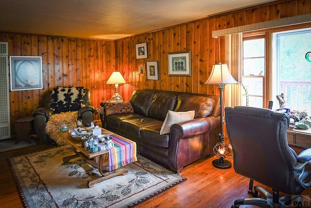 8946 Central Ave, Beulah, CO 81023 - living area featuring wood finished floors, wood walls, a heating unit, and a desk