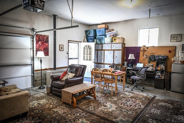8946 Central Ave, Beulah, CO 81023 - garage featuring a garage door opener, freestanding refrigerator, and a desk