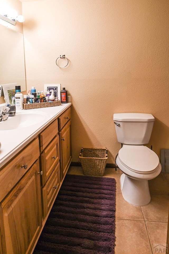 8946 Central Ave, Beulah, CO 81023 - bathroom with vanity, toilet, tile patterned flooring, and baseboards