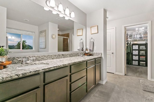 6740 Spruce Hill Ct, Colorado Springs, CO 80923 - full bathroom with a stall shower, double vanity, a spacious closet, and tile patterned flooring