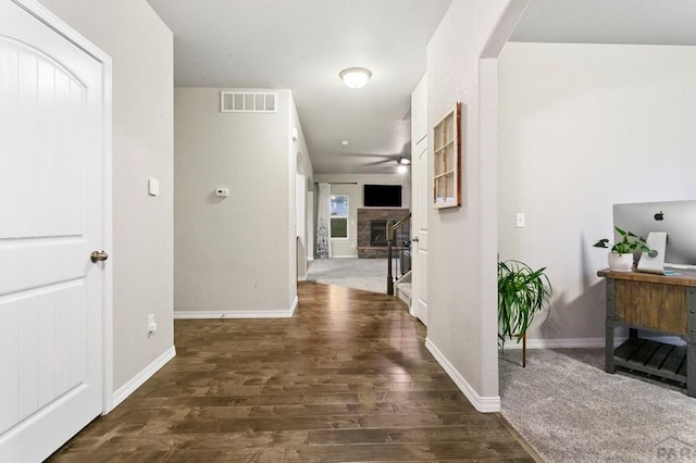 6740 Spruce Hill Ct, Colorado Springs, CO 80923 - corridor featuring wood finished floors, arched walkways, and stairway