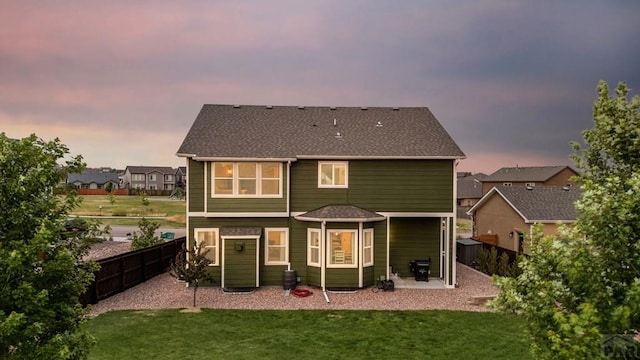 6740 Spruce Hill Ct, Colorado Springs, CO 80923 - back of property at dusk with a patio and a fenced backyard