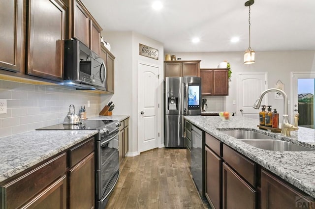 6740 Spruce Hill Ct, Colorado Springs, CO 80923 - kitchen with stainless steel appliances, dark wood-style floors, backsplash, decorative light fixtures, and recessed lighting