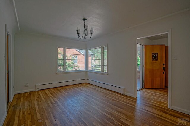 unfurnished dining area featuring a notable chandelier, baseboards, and wood finished floors