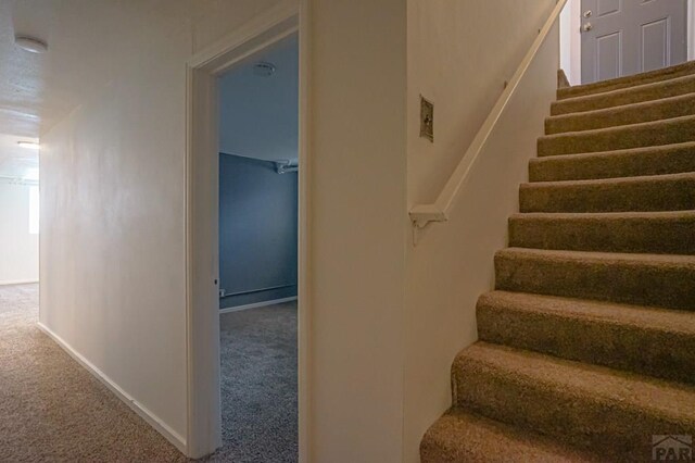 stairs with carpet flooring and baseboards